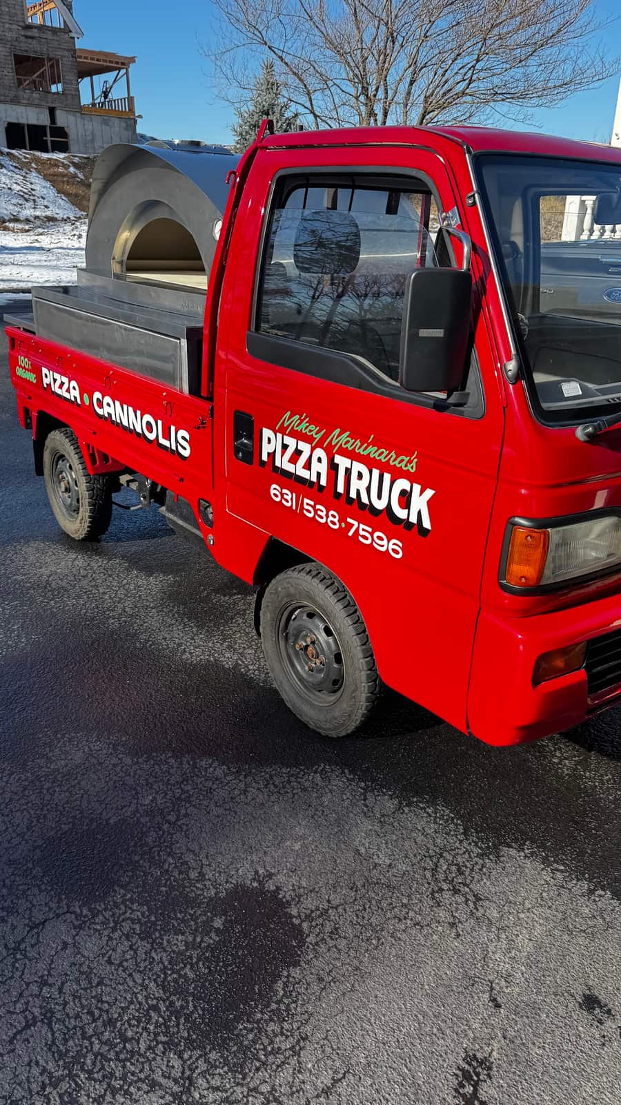 The front of the pizza truck with the oven behind the cab